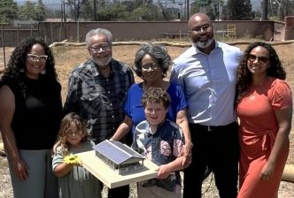 The Wood family stands on their cleared lot with hope for rebuilding with help from the program by SGV Habitat and the Altadena Builds Back Foundation.